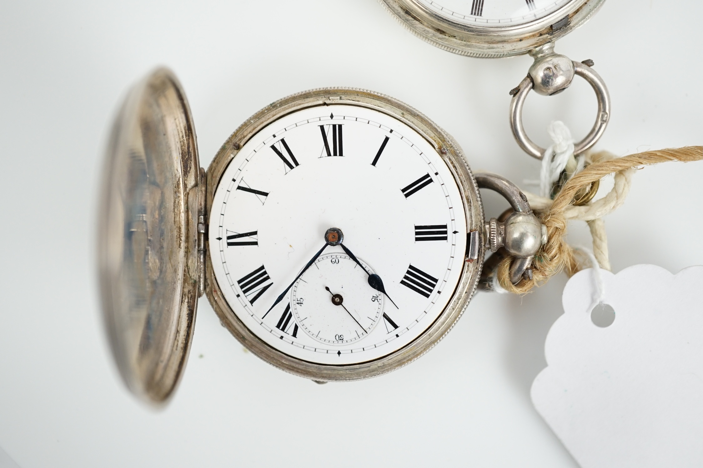 A Victorian silver hunter keywind pocket watch and an engine turned white metal pocket watch.